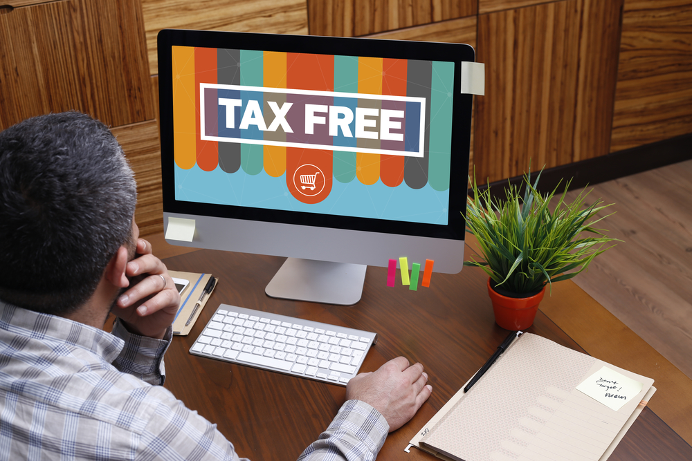 Man using computer with TAX FREE concept on screen